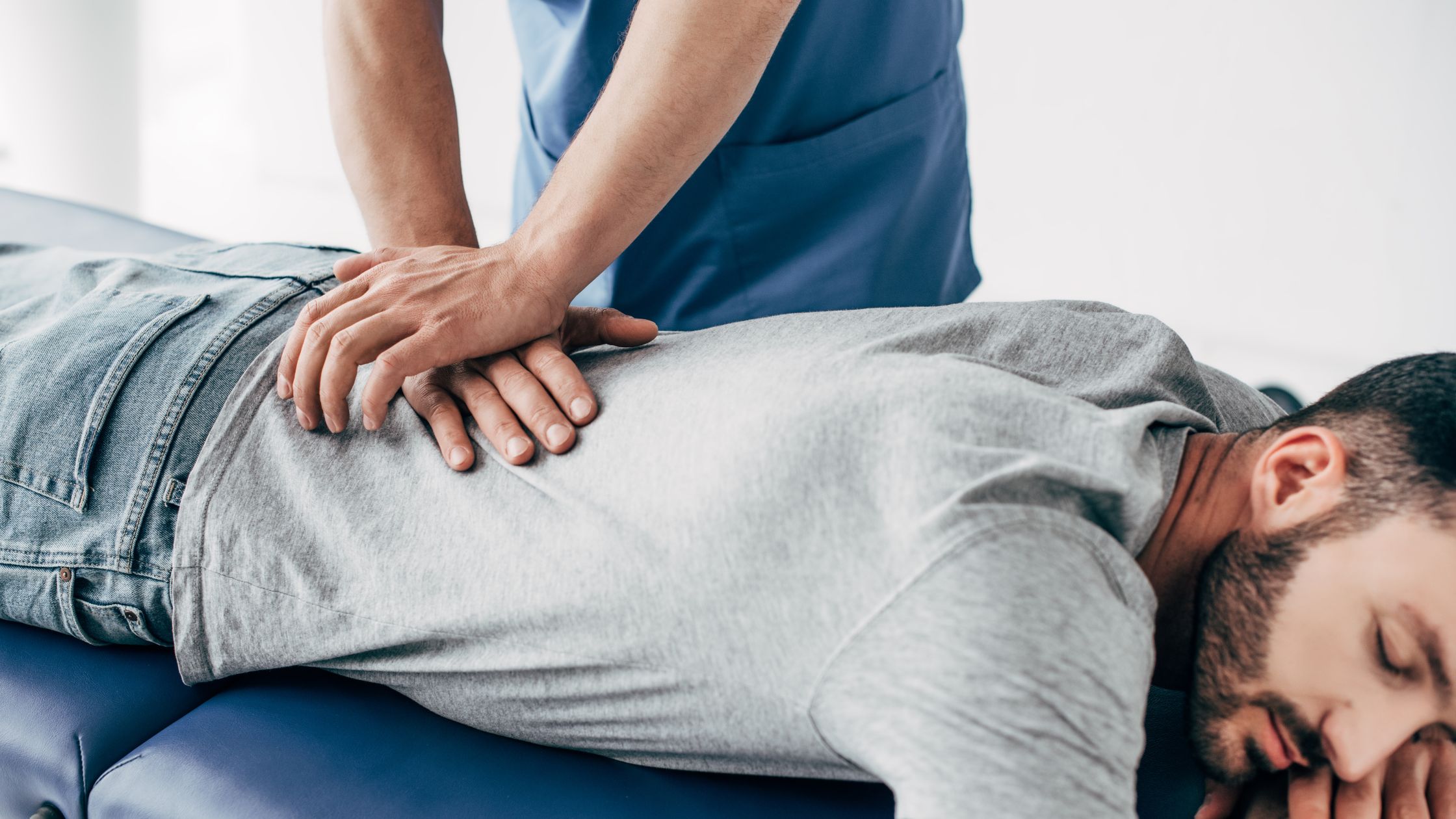A person getting there backed worked on by a chiropractor.