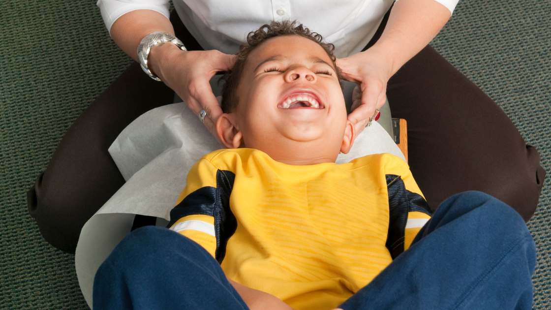 Child getting adjusted by chiropractor