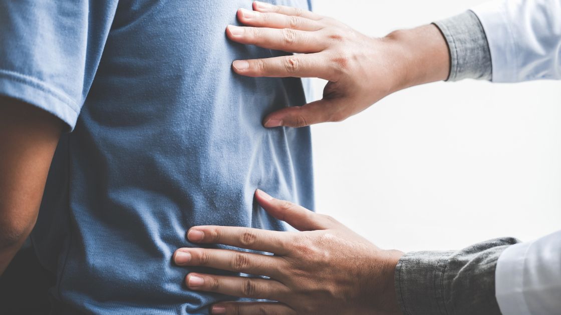 A person being examined by a chiropractor.
