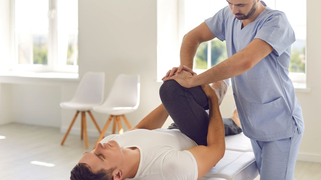 A chiropractor working on someones legs.
