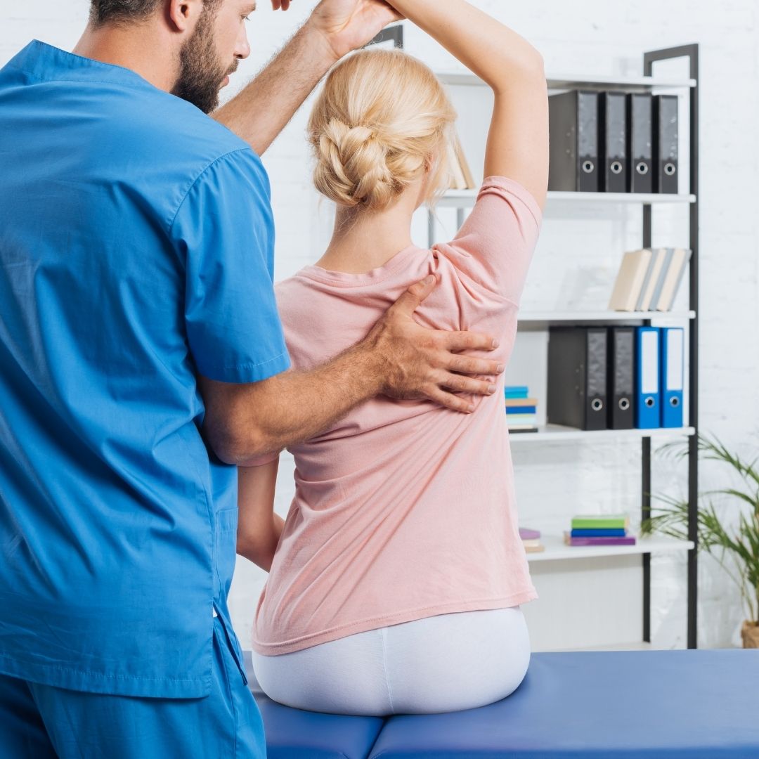 Chiropractor performing care to a client